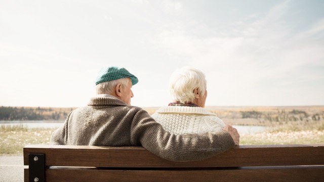 Zwei alte Menschen sitzen auf einer Bank
