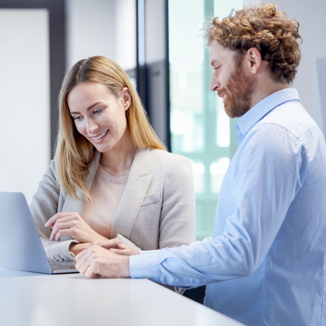 Mann und Frau in Beratungssituation vor Laptop