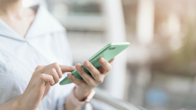 A woman holding a smartphone in her hand