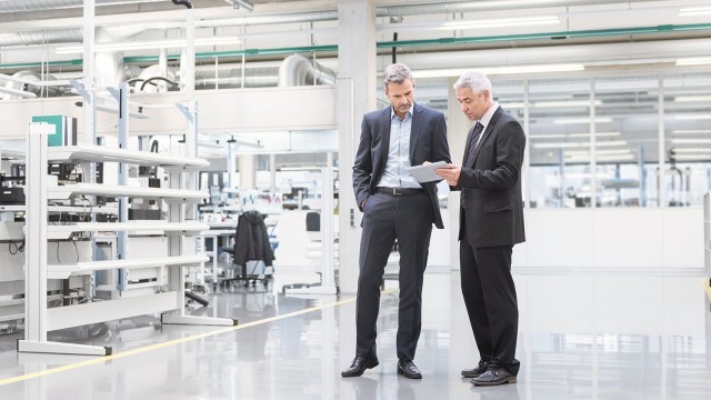 Two men discussing documents