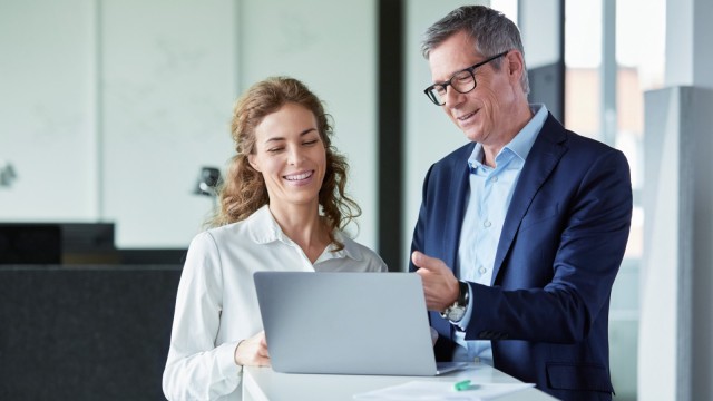 Two colleagues looking at something on the laptop