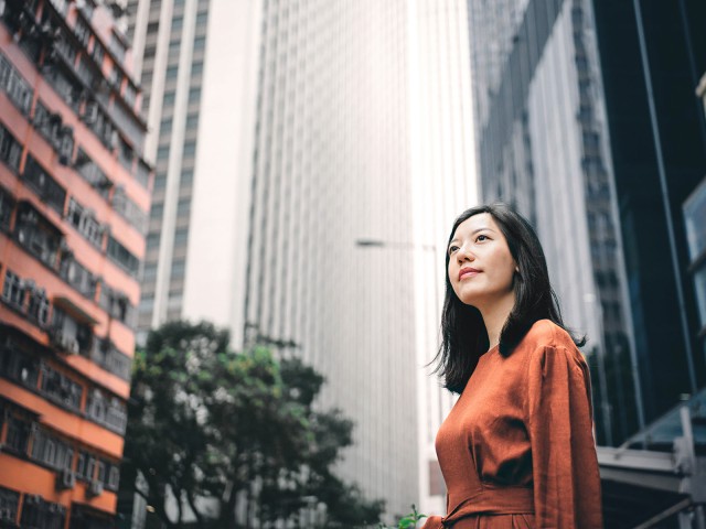 A young woman is standing in the city center