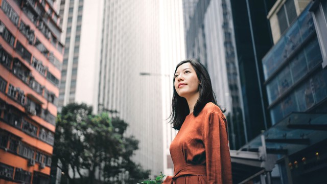 A young woman is standing in the city center